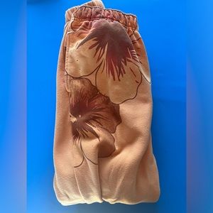 Orange sweatpants with Hawaiian flowers